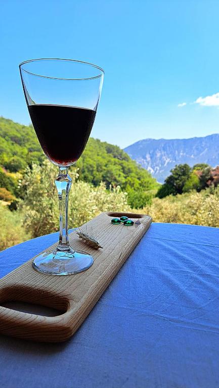 a glass of wine sitting on top of a table at Adrasan village house in Kumluca