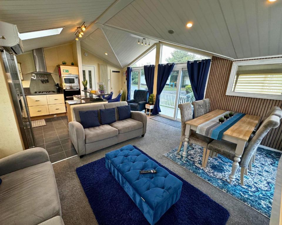 a living room with a couch and a table at Sunset 5 - Southview Holiday Park Skegness in Skegness