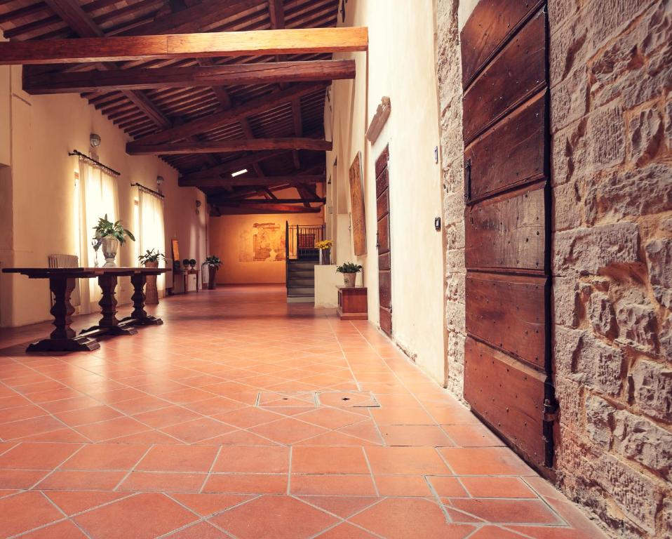 an empty hallway in a building with a brick wall at Residenza Antica Canonica in Città di Castello