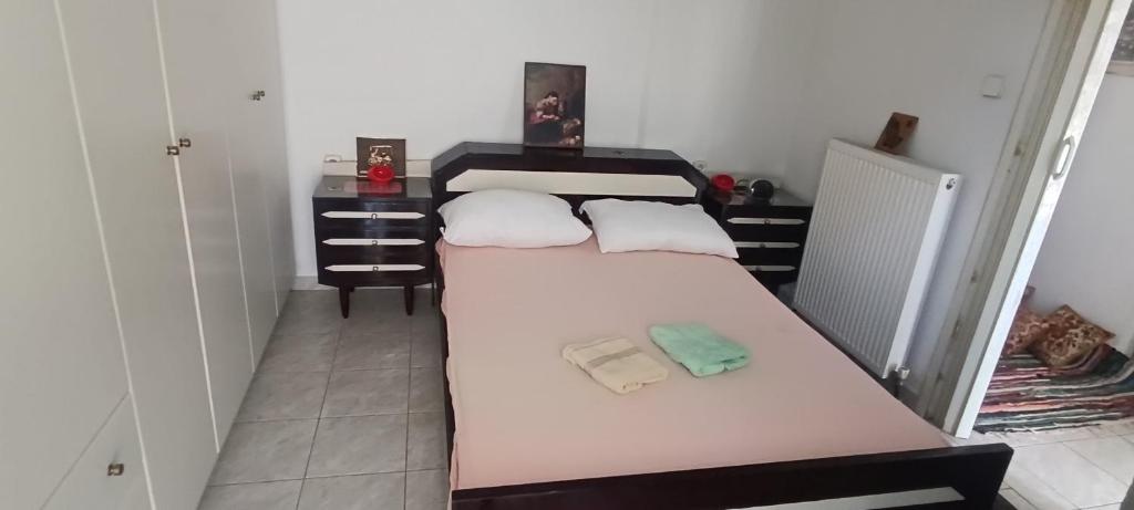 a bedroom with a bed with two towels on it at CHRYSA' S House in Volos