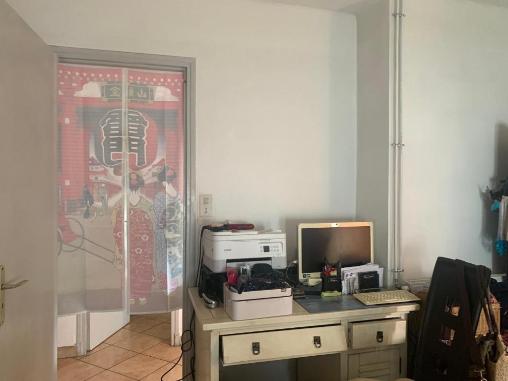 an office with a desk with a computer on it at Loft in Bezannes-les-Reims
