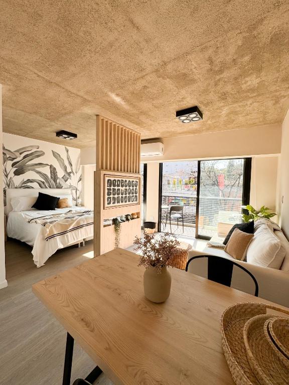 a living room with a table and a bedroom at Anywhere Palermo Soho in Buenos Aires