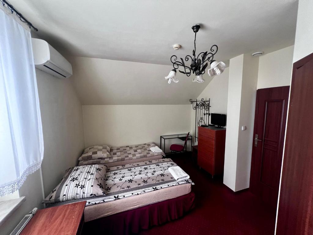 Postel nebo postele na pokoji v ubytování Zajazd Skorpion B&B