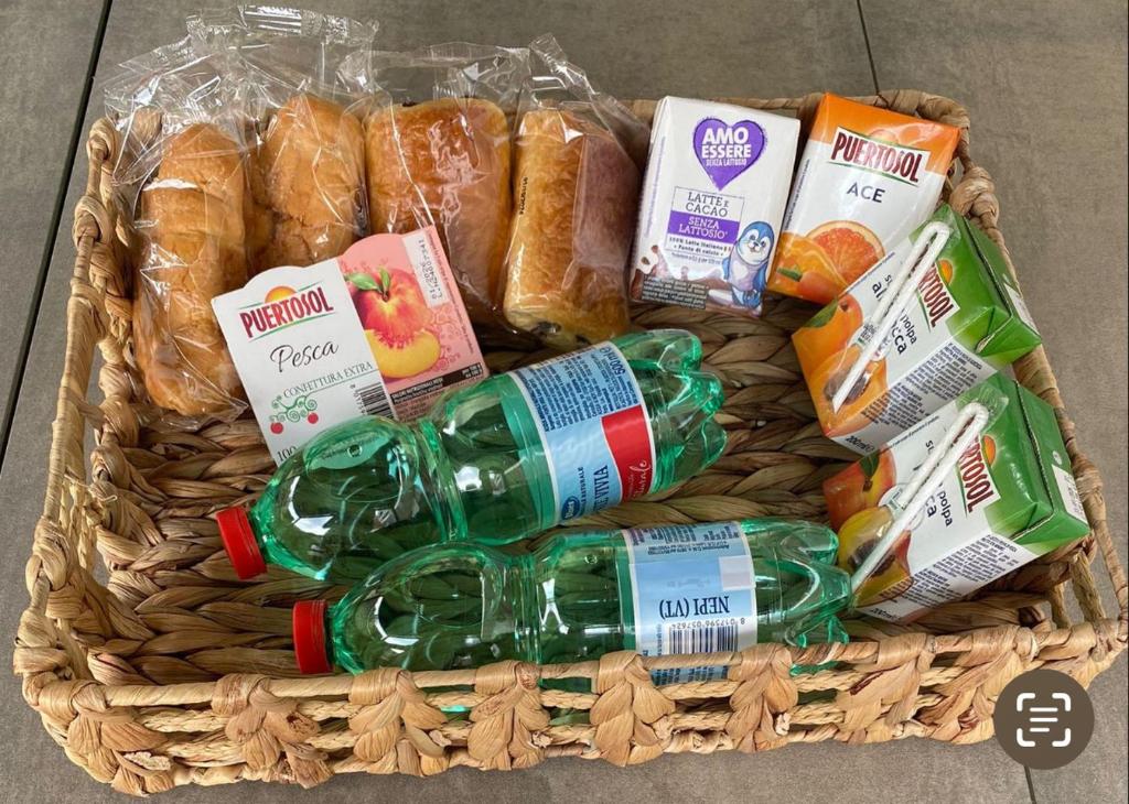 a basket filled with bread and drinks and food at Casa Lella 7 Marino in Marino
