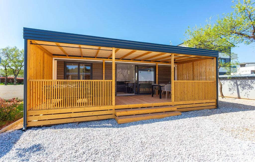 a small house with a large deck at Batana Mobile Home in Banjole