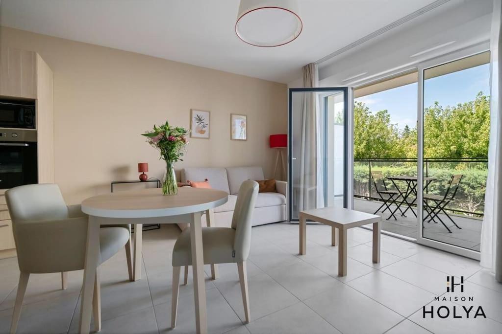 un salon avec une table, des chaises et un canapé dans l'établissement À Avignon - Le Reposant - 373B, à Avignon