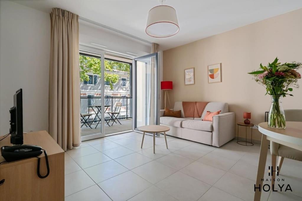 un salon avec un canapé et une table dans l'établissement Le Soyeux - À Avignon - 375B, à Avignon