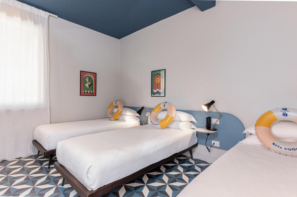 Postel nebo postele na pokoji v ubytování Riva Rooms