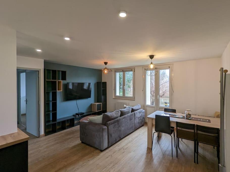 un salon avec un canapé et une table dans l'établissement Appartement proche Parc Expo Nancy, à Jarville-la-Malgrange