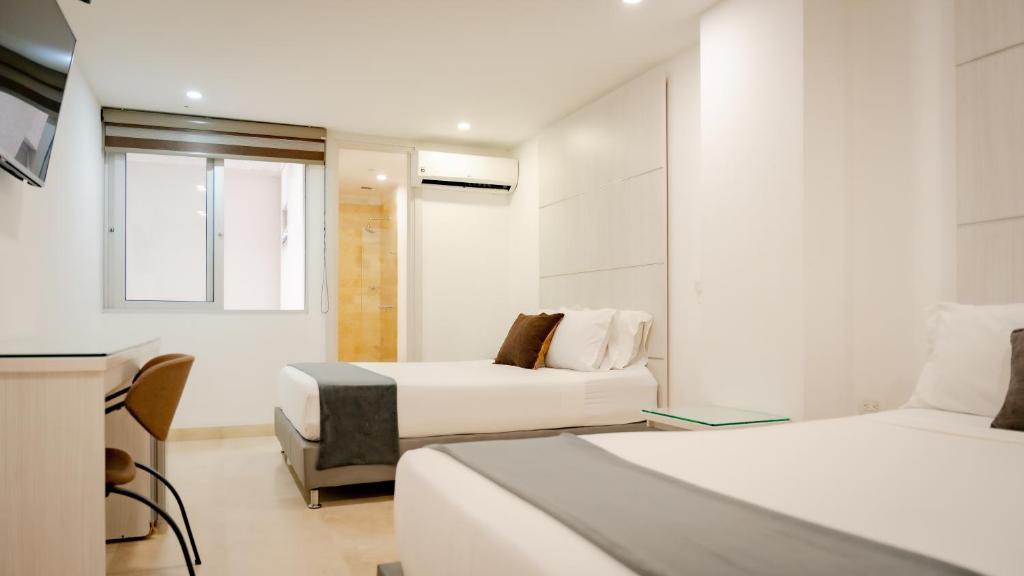 Postel nebo postele na pokoji v ubytování Hotel Madeiro