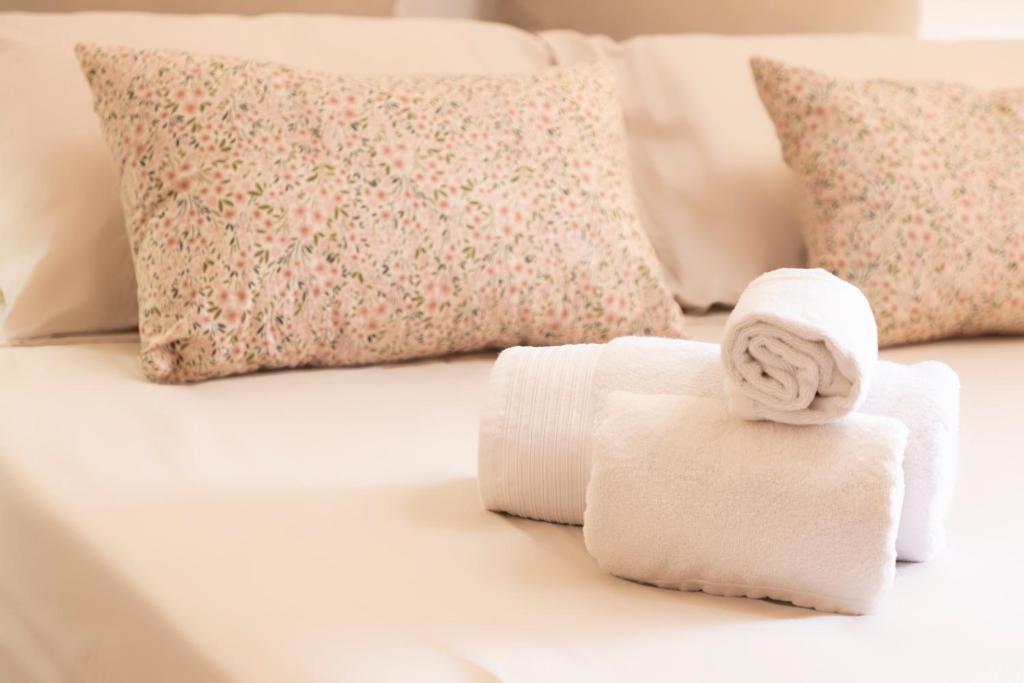 a white bed with towels and pillows on it at CA' DU GU' Free wifi - centrale in Carloforte