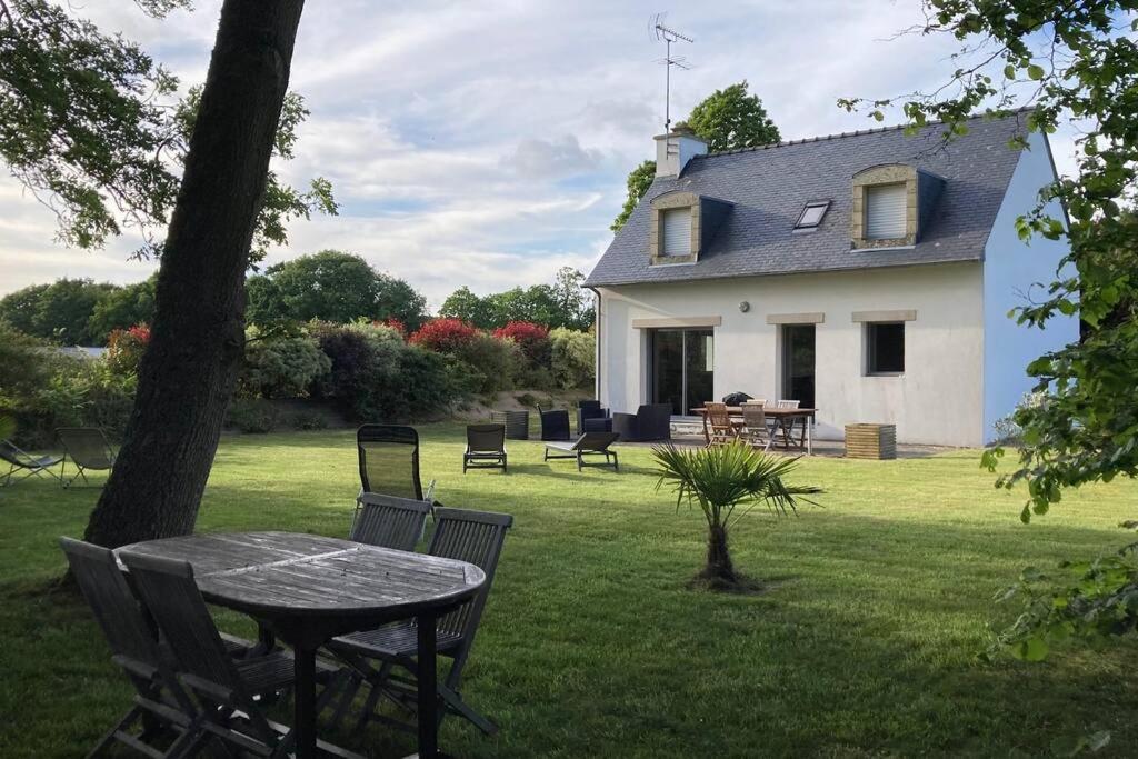 une table et des chaises devant une maison dans l'établissement Comfortable house - Le Penty des Grands Champs, à Combrit