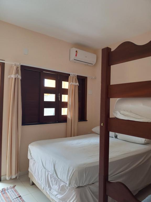 Postel nebo postele na pokoji v ubytování Dendê Jazz Hostel e Pousada