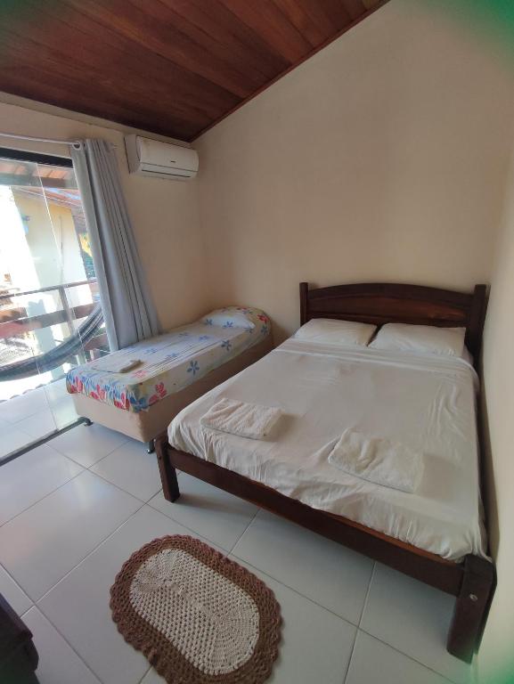 Postel nebo postele na pokoji v ubytování Dendê Jazz Hostel e Pousada