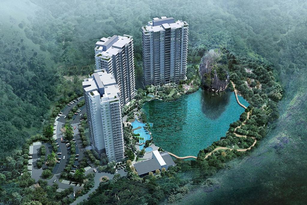 an aerial view of two tall buildings and a lake at IPOH All Suite Resort, Jalan Haven, Persiaran Lembah Perpaduan, Ipoh Perak in Ipoh