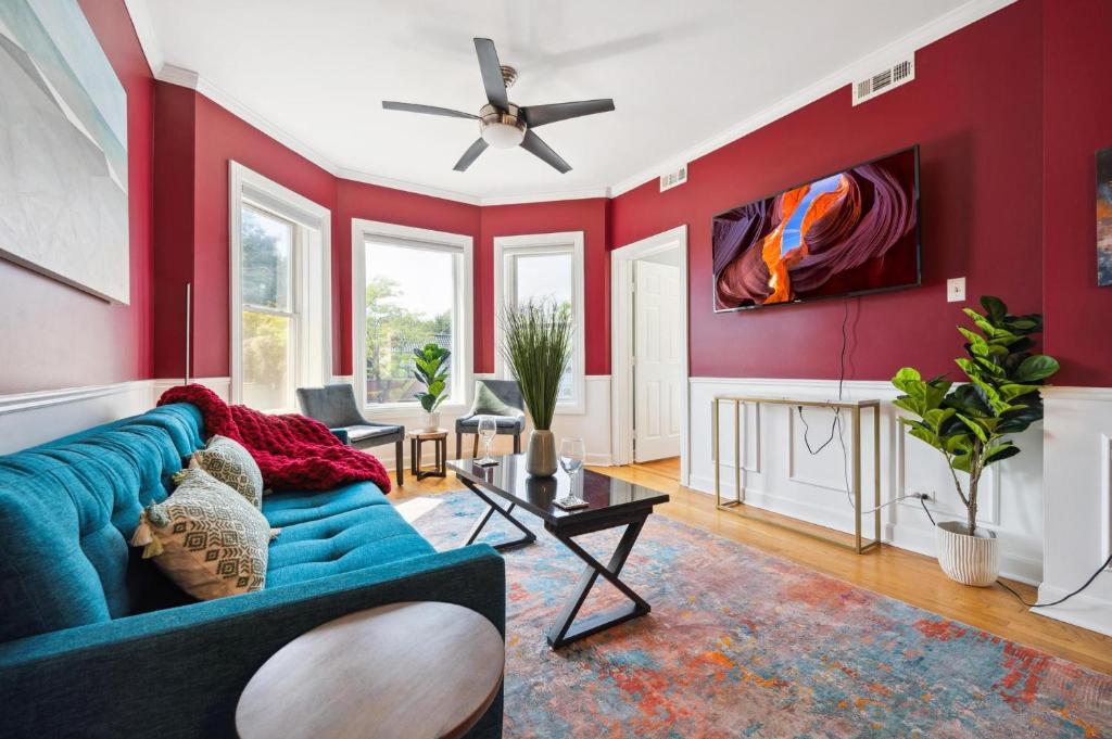 a living room with a blue couch and red walls at Wrigley 2BR, 1BA with Free Parking in Chicago