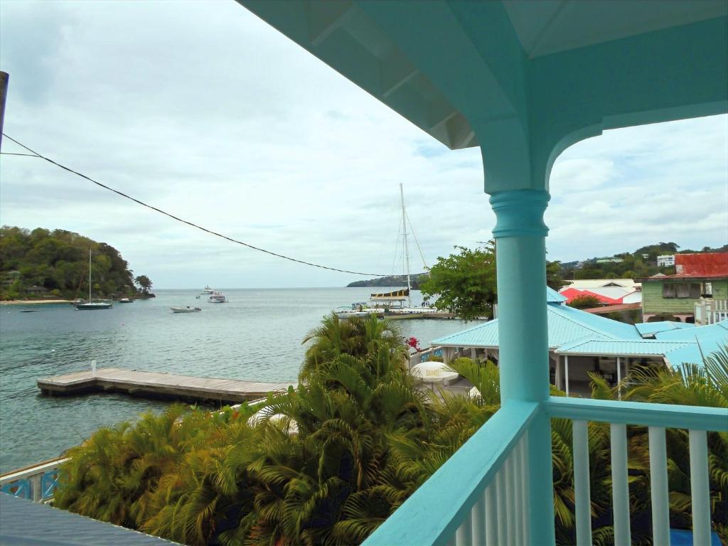 a view of the water from a house balcony at Basil At Villa in Arnos Vale