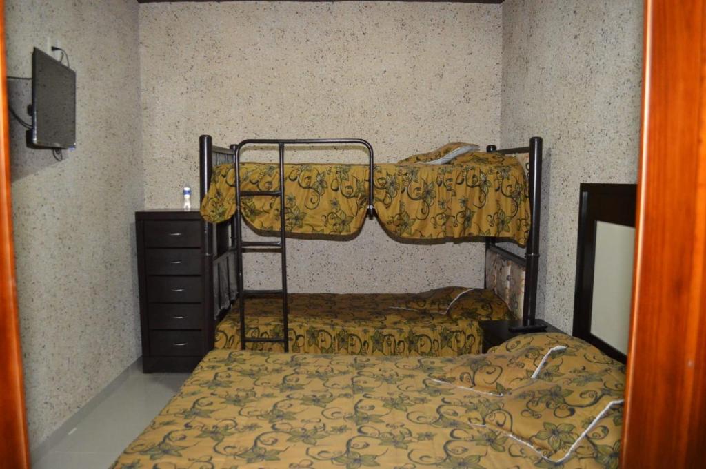 Postel nebo postele na pokoji v ubytování Hotel Guadalupe Bernal