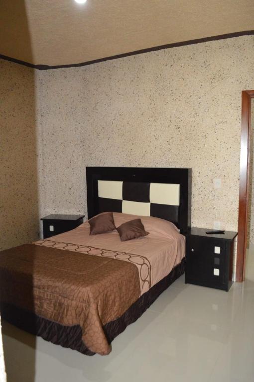 Postel nebo postele na pokoji v ubytování Hotel Guadalupe Bernal