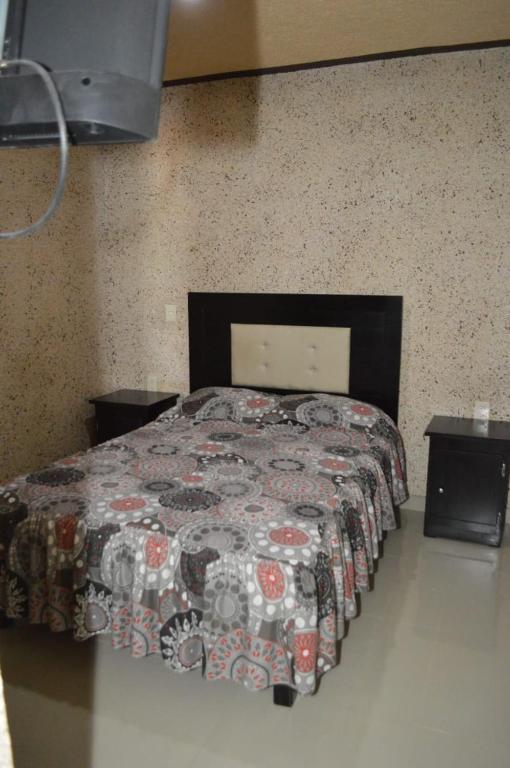 Postel nebo postele na pokoji v ubytování Hotel Guadalupe Bernal