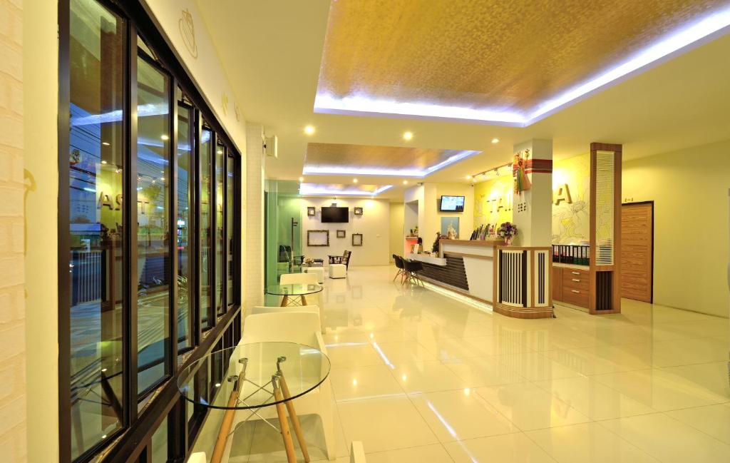 a lobby of a hospital with tables and chairs at Tairada Boutique Hotel in Krabi town