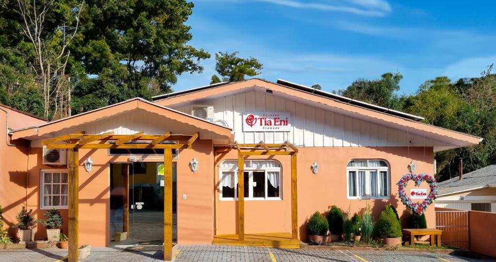 a fast food restaurant with a building at Pousada Tia Eni in Gramado