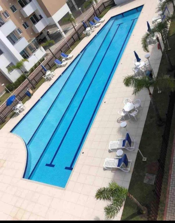 an overhead view of a large swimming pool with chairs at Praia canavieiras in Florianópolis