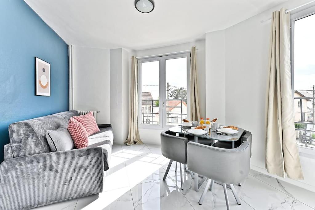 un salon avec un canapé et une table dans l'établissement Appartement conviviale et lumineux - III, à Gournay-sur-Marne