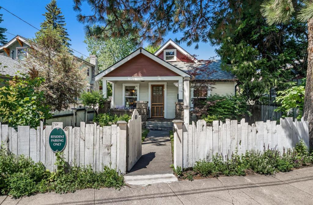 a white picket fence in front of a house at Bluebird Day - River West in Bend