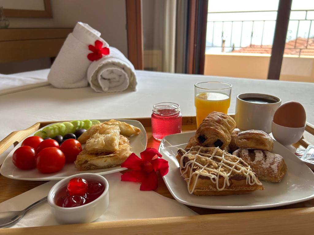 a tray with two plates of breakfast food on a table at Calm View in Vasiliki