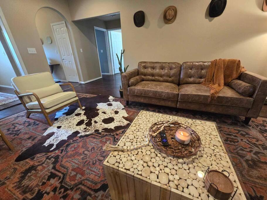 a living room with a couch and a table at 4 bedroom pet friendly grill under 5 min to airport and Choctaw Casino in Calera
