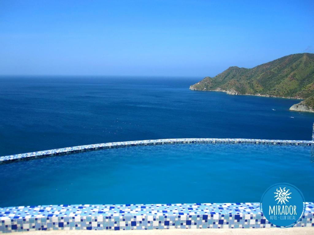 an aerial view of a swimming pool next to the ocean at Hotel TNT Mirador in Taganga