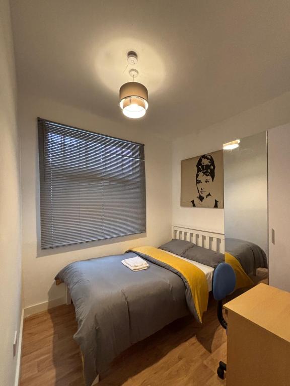 a bedroom with a bed and a window at Sterling Suites Ealing in Ealing