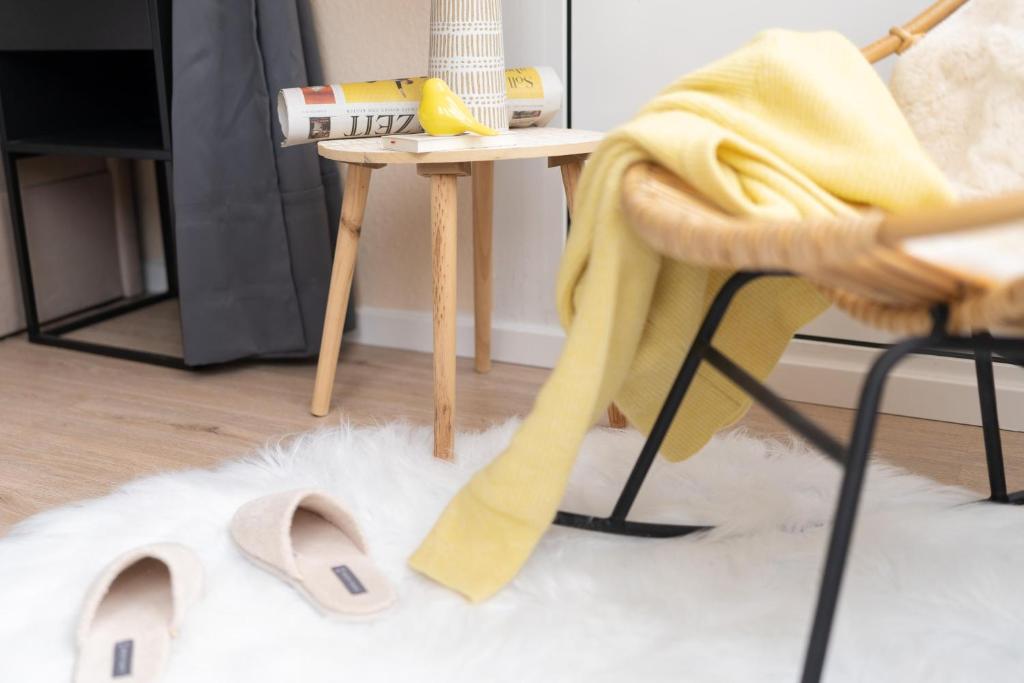 a room with a table and a chair and a white rug at Appartement Cappel Whg 16 in Cappel-Neufeld