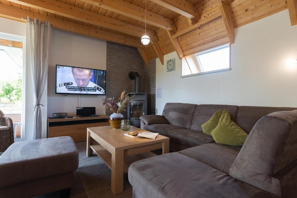 a living room with a couch and a table at Ferienhaus Mellumplate 50 in Dorum Neufeld