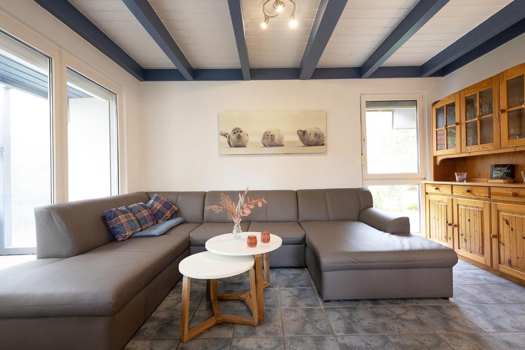 a living room with a couch and a table at Ferienhaus Vogelsand 08 in Dorum-Neufeld