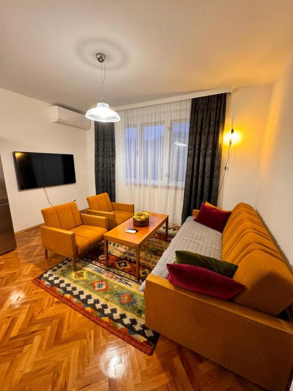 a living room with a couch and a table at Nostalgia apartments in Jajce