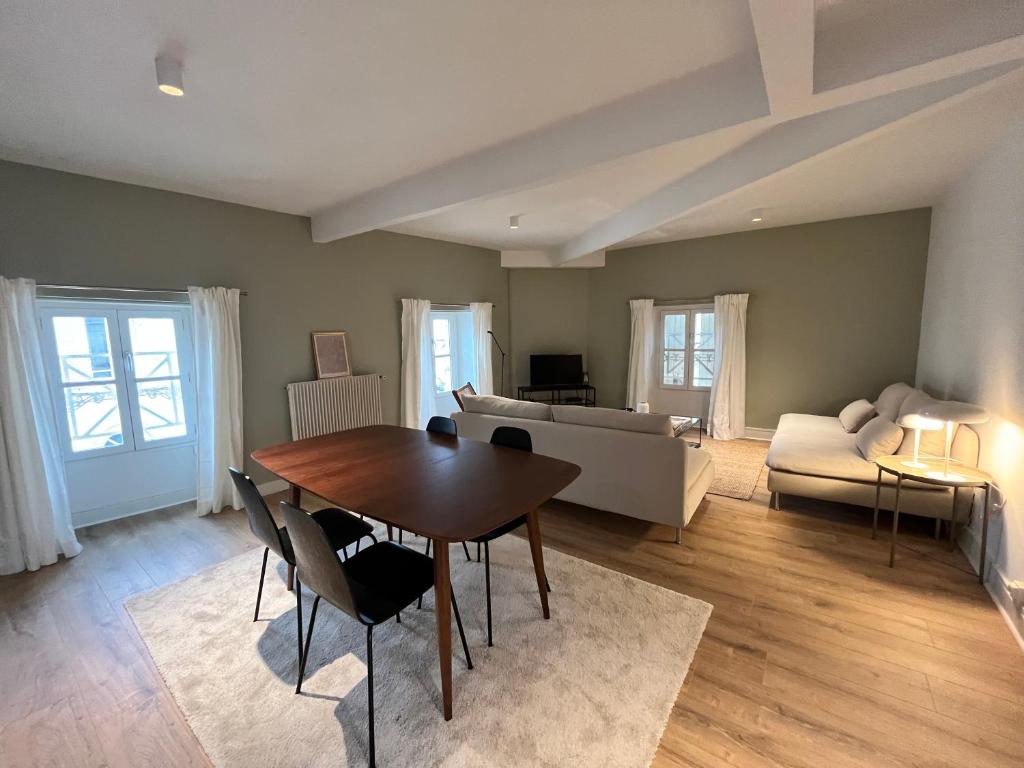 un salon avec une table et un canapé dans l'établissement Appartement entier - Centre historique, à Angoulême