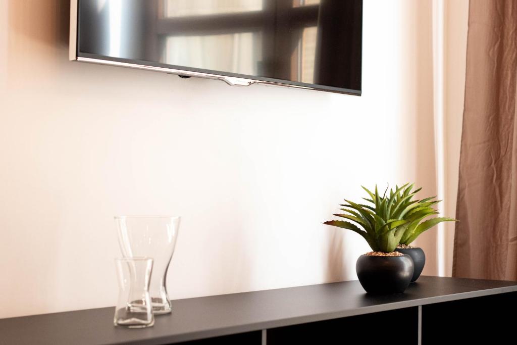 Televízia a/alebo spoločenská miestnosť v ubytovaní Elvira 54 Apartment