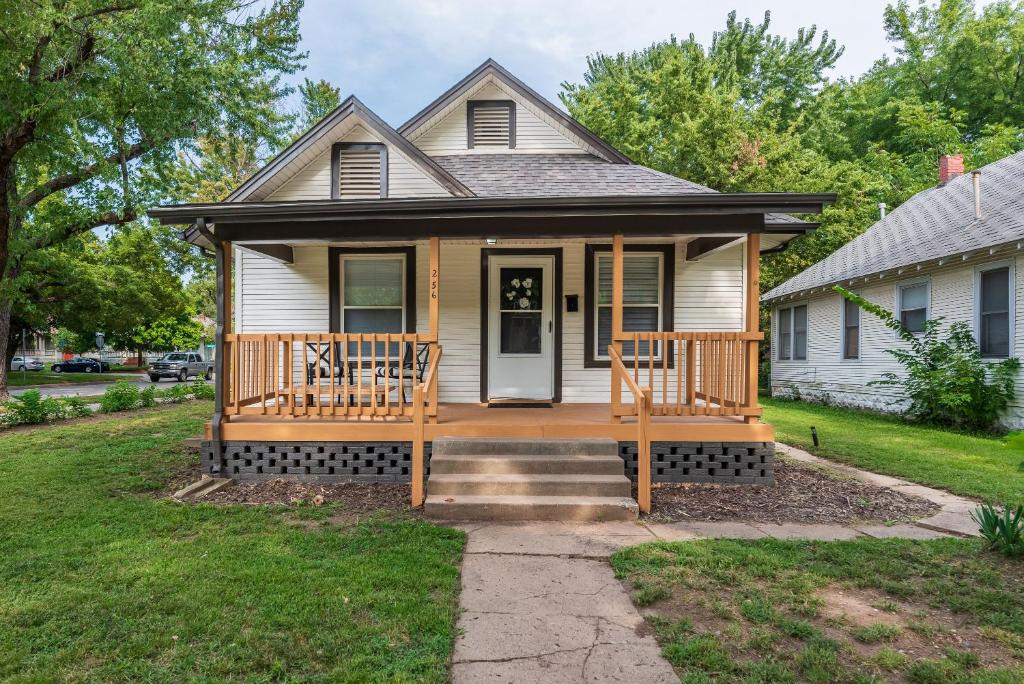 a house with a large porch with a deck at Beautiful 2 Bed 1 Bath home near College Hill in Wichita