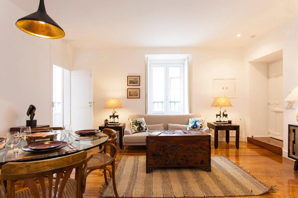 a living room with a table and a couch at Charming Apartment in Alfama in Lisbon