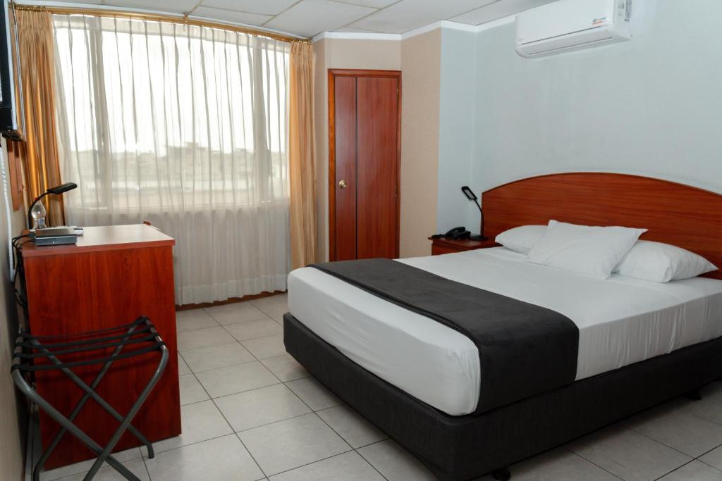 Postel nebo postele na pokoji v ubytování Grand Hotel Machala