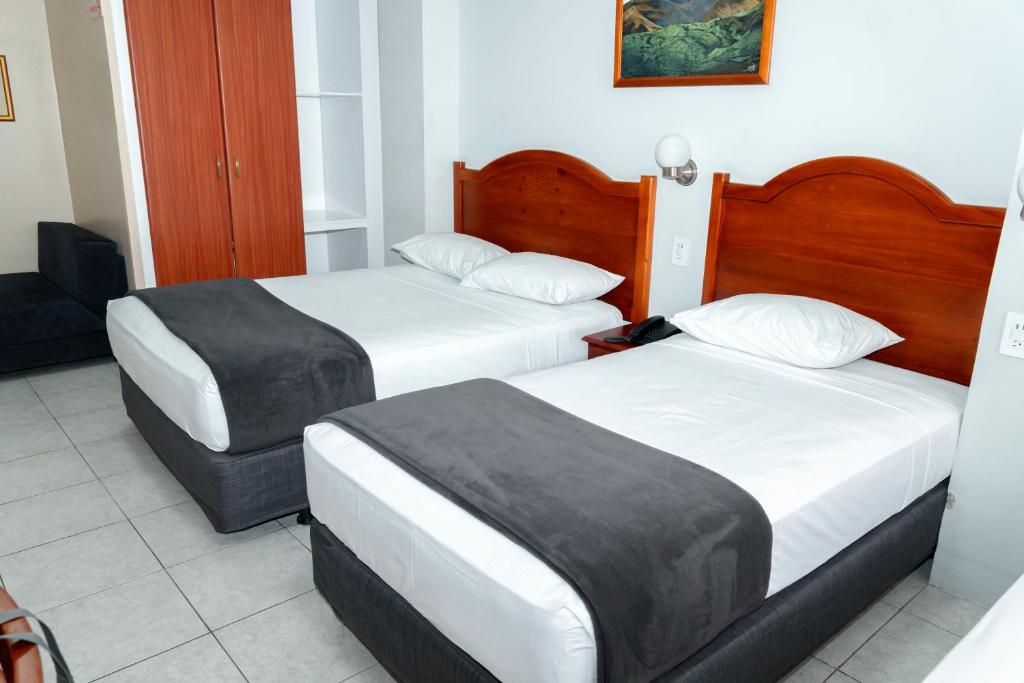 Postel nebo postele na pokoji v ubytování Grand Hotel Machala