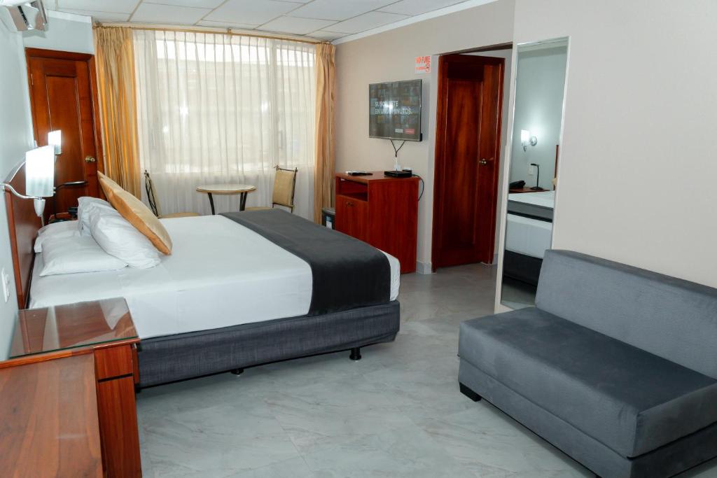 Postel nebo postele na pokoji v ubytování Grand Hotel Machala