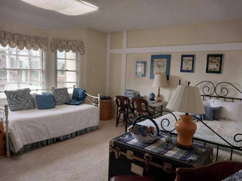 a bedroom with a bed and a table with a lamp at Carmel Comfort in Carmel