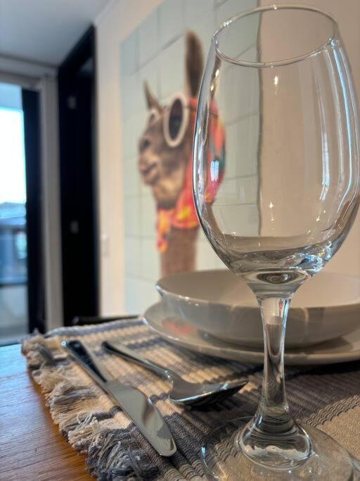a wine glass sitting on top of a table at Apartment By Toore Patagonia in Puerto Natales