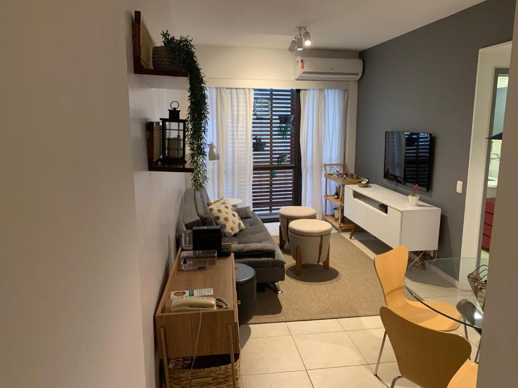 a living room with a couch and a table at Flat Leblon inn in Rio de Janeiro