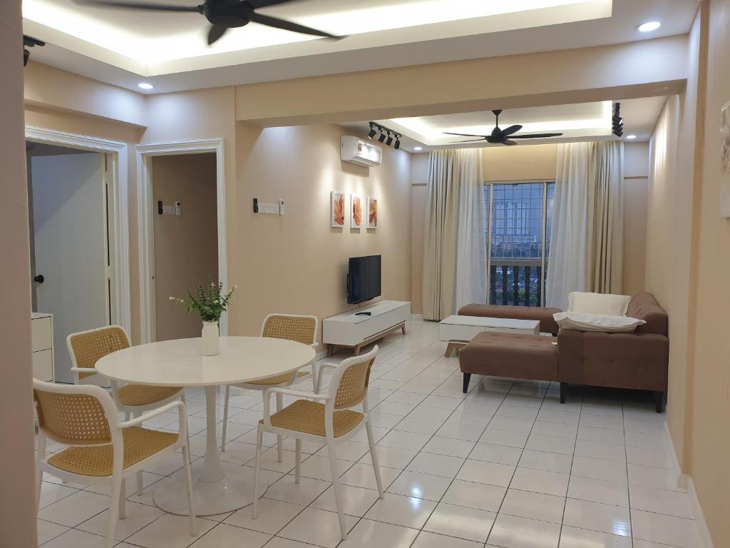 a living room with a table and a couch at Sri Raya Apartment Bandar Baru Bangi in Kajang