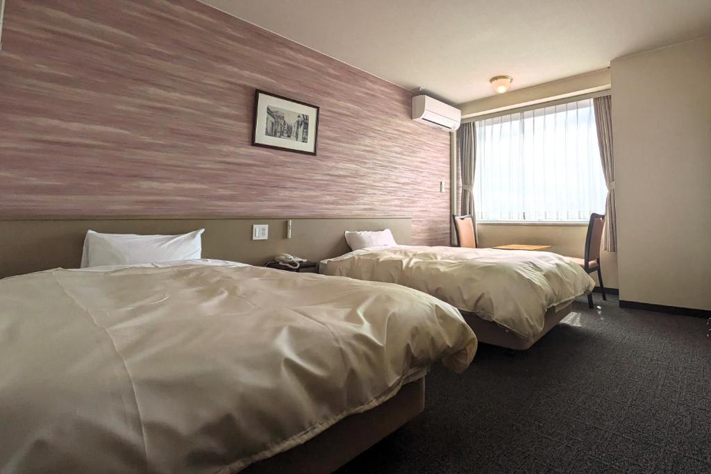Postel nebo postele na pokoji v ubytování Mikuni Ocean Resort&Hotel
