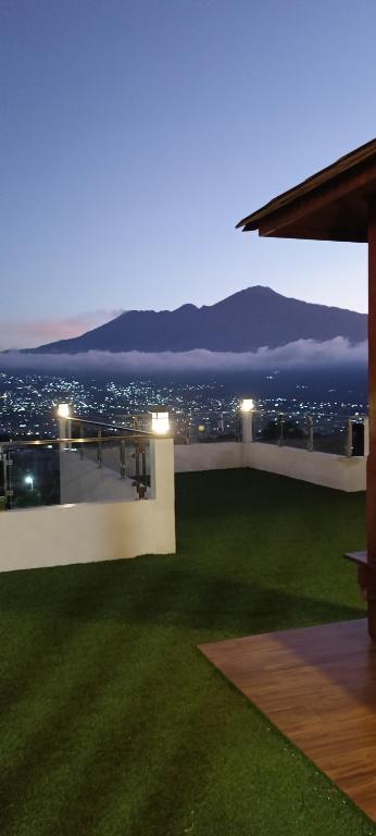 a balcony with a view of a city at night at Dream Hills Villa in Batu